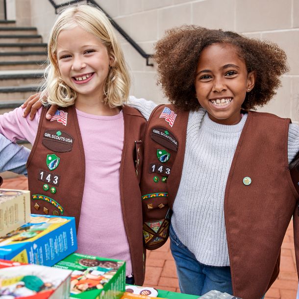 Two Brownie Girl Scouts at a cookie booth