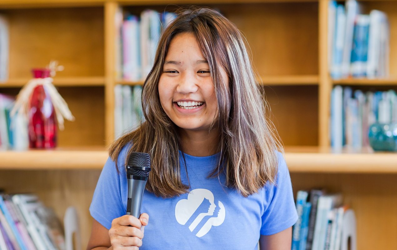 Girl speaking into a microphone