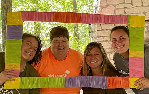 four gswo staff members smiling together at a staff picnic