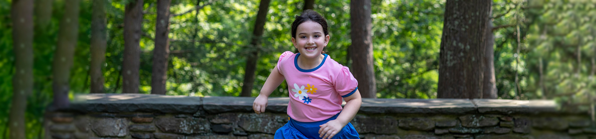  A Girl Scout Daisy runs excitedly through the woods!  