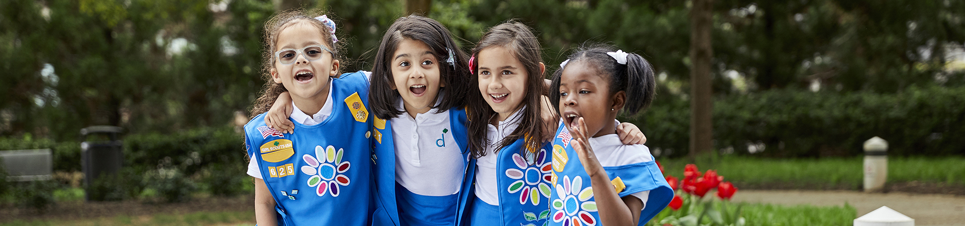  Group of Junior Girl Scouts smiling and laughing outdoors 