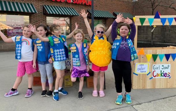 A troop of Daisy Girl Scouts at a cookie booth