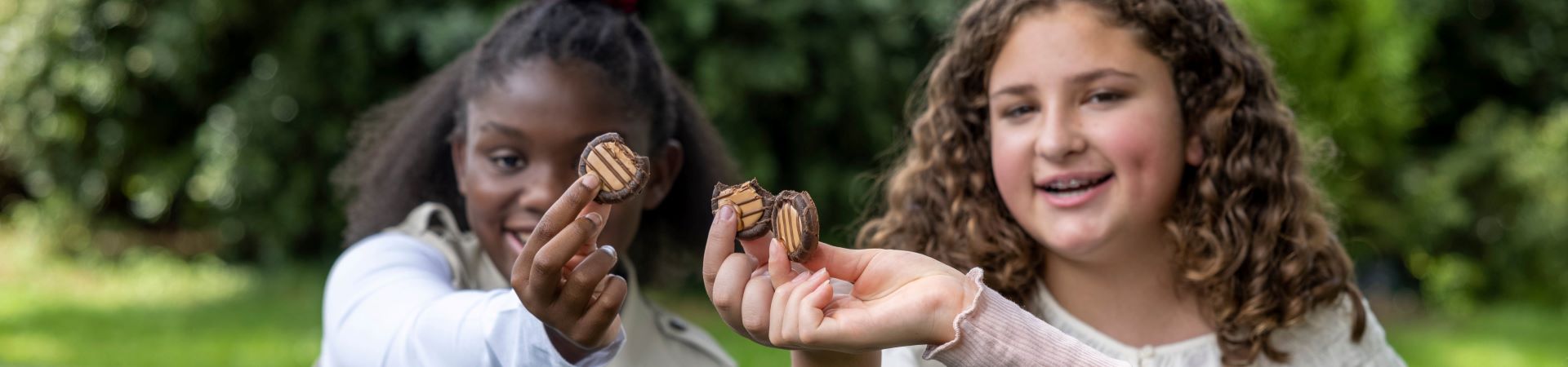  Girl Scouts holding Adventureful cookies 