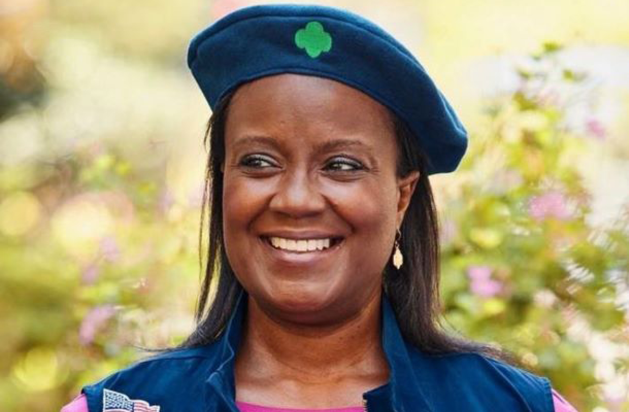 A volunteer wearing her Girl Scout uniform