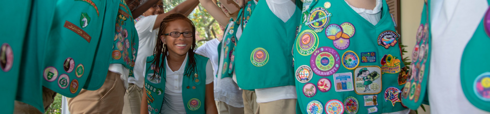  A girl walking through a tunnel made by her troop 