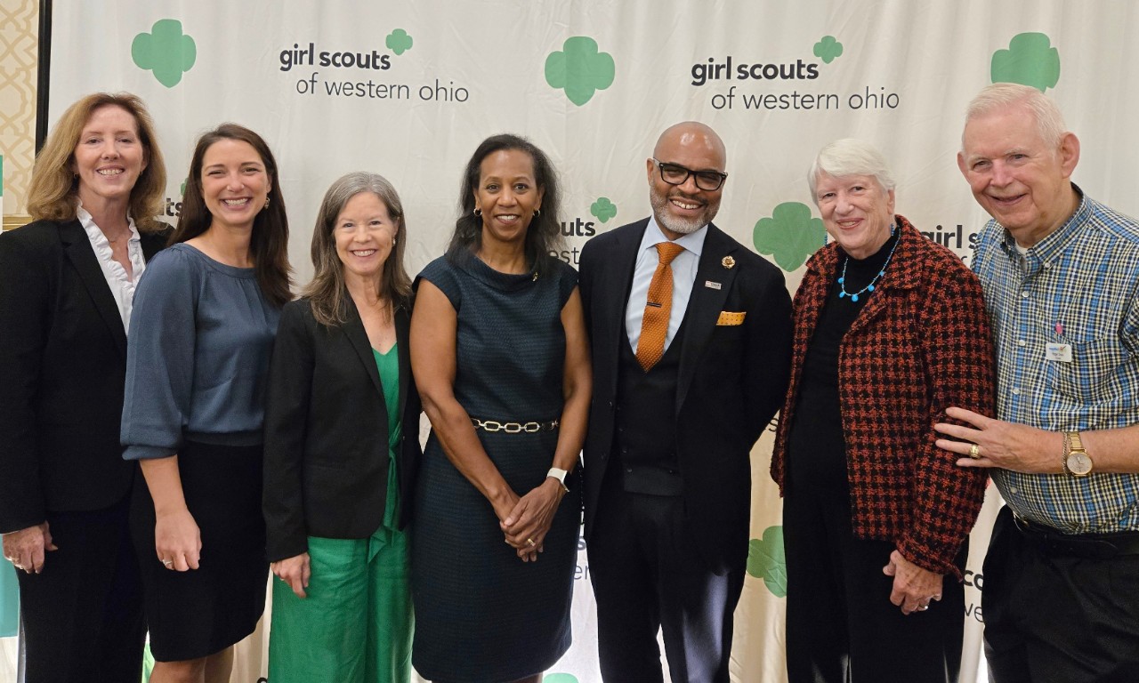 Past Changemaker honorees in front of Girl Scouts of Western Ohio banner